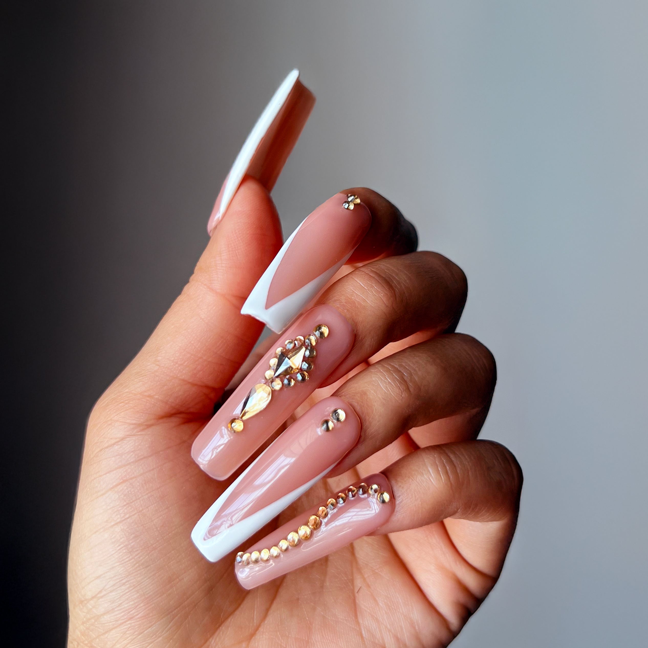 Frenchella XXL press-on nails with nude and white reverse French tips, decorated with gold rhinestones and gems