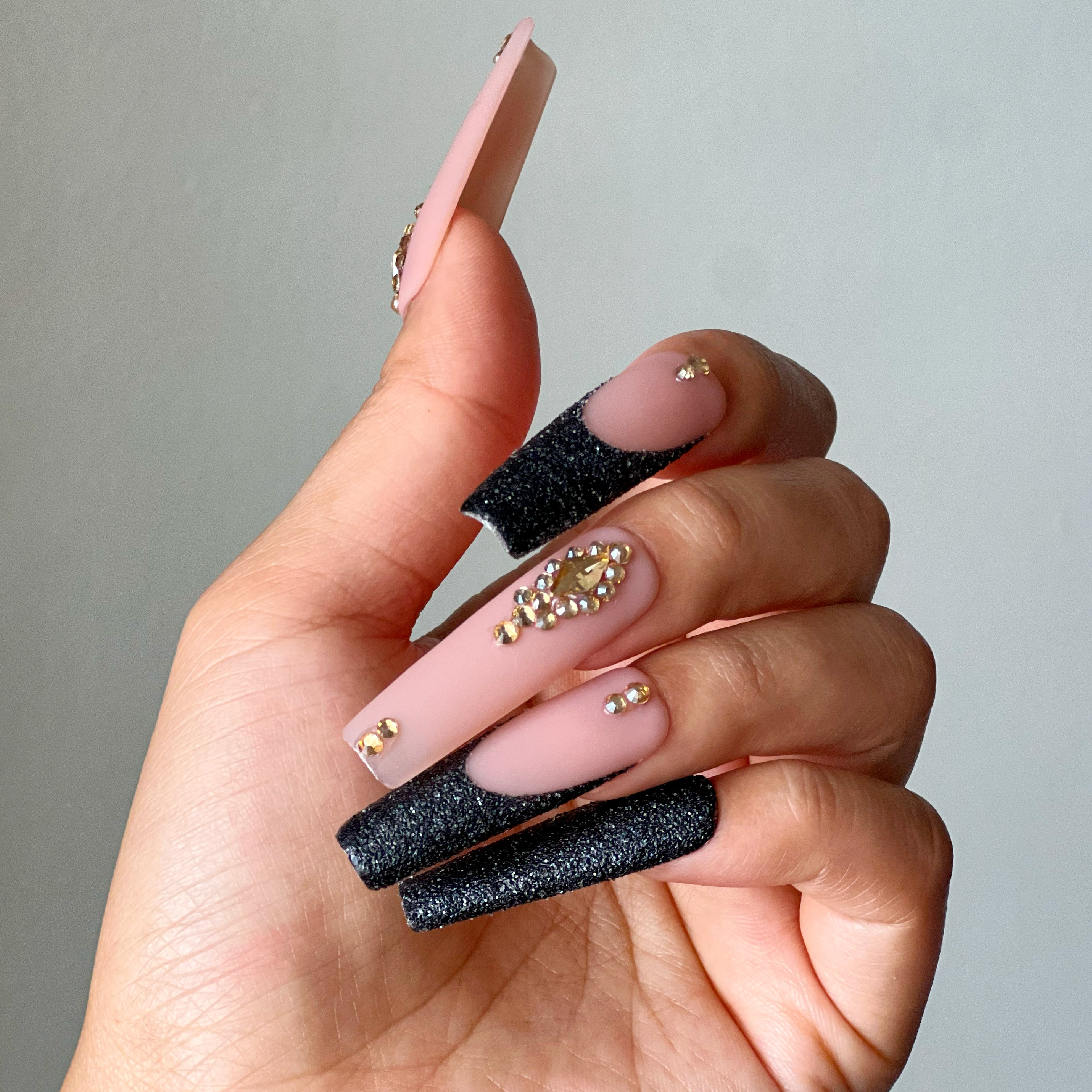 Golden Eclipse XL square press-on nails with black glitter French tips and gold rhinestone accents