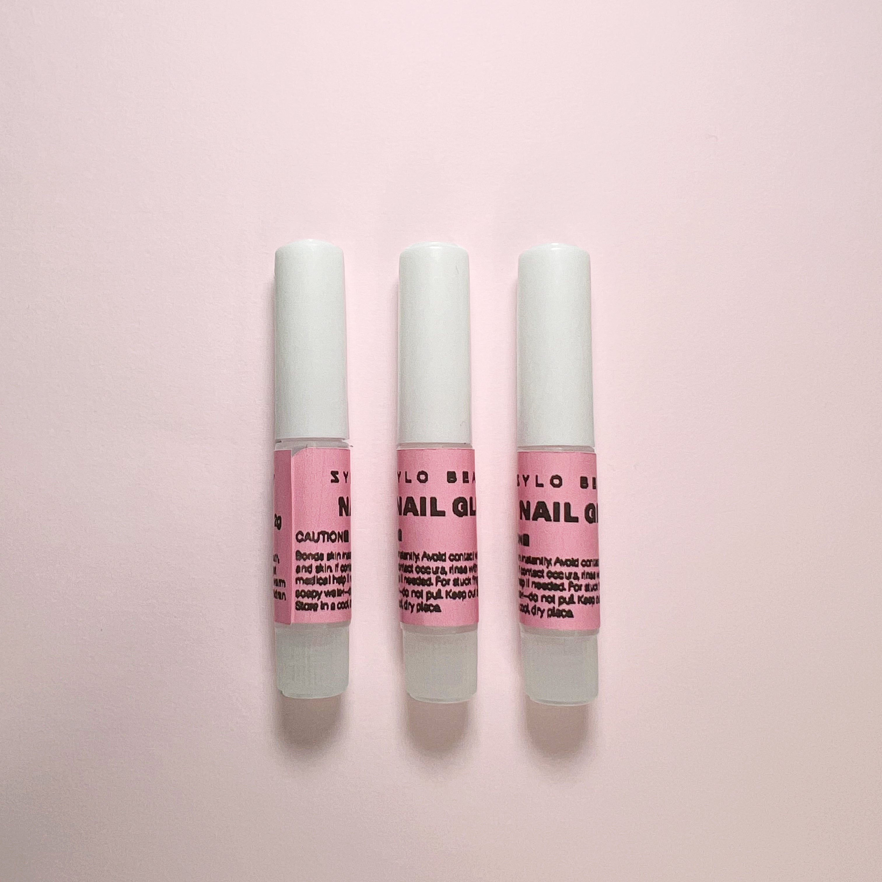 Set of three 2g nail glues for press-on nails, offering strong, fast-drying hold for long-lasting manicures and nail art.